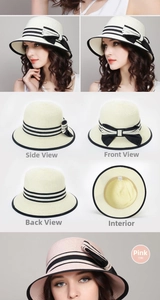 Detailed close-up of straw sun hat featuring elegant black bow and metal logo accent