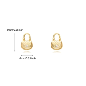 Detailed view of gold handbag-shaped stud earrings with quilted pattern and small gemstones