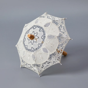 Vintage white lace wedding umbrella with carved wooden handle for bridal photography props