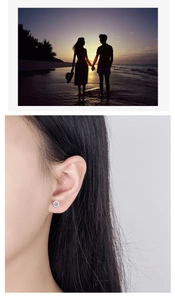 Detailed view of round zircon stud earring worn by a model in a bezel setting style