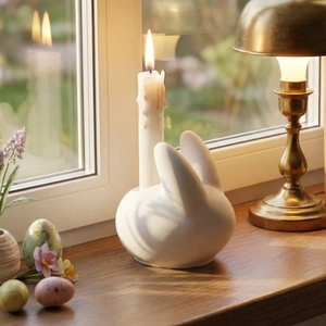Minimalist white ceramic rabbit candle holder for Easter home decor on a wooden windowsill