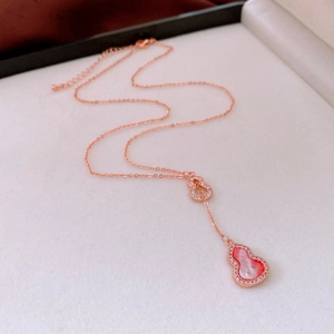 Detail of rose gold double gourd necklace with pink shell inlay and zircon accents