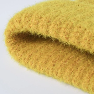 Bright yellow thick feather yarn knit beanie with soft plush texture for winter warmth