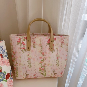 Floral canvas tote bag with pink flower pattern and durable leather top handles