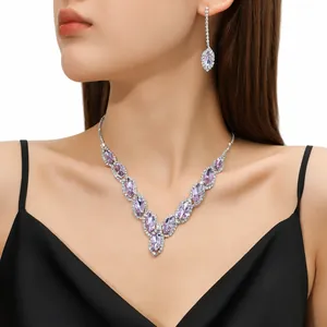 Detailed view of elegant bridal necklace set with purple marquise crystals on model
