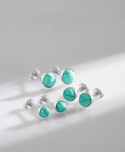 Macro shot of S925 sterling silver turquoise stud earrings in three size variations
