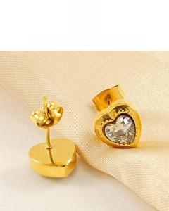 Detail of heart-shaped zircon earrings with 18K gold plating on champagne silk cloth