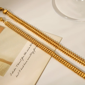 Detail of 18K gold stainless steel layered bead and flat mesh chain bracelets set