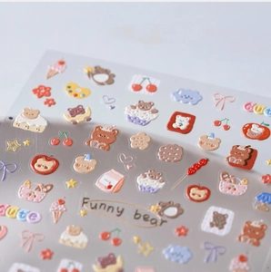 Close-up of 5D embossed nail art stickers with cute bears, cupcakes and hearts