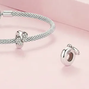 S925 sterling silver charm bracelet featuring sparkling baby feet pendants on pink stand