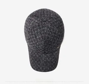 Top view of deep grey herringbone wool baseball cap showing detailed winter fabric texture