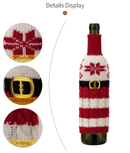 Close-up detail view of the red and white knit Christmas wine bottle cover with snowflake pattern.