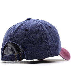Detail of vintage washed cotton baseball cap featuring metal buckle and contrast brim