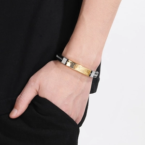 Men's black silicone bracelet with engraved stainless steel metal plates on wrist