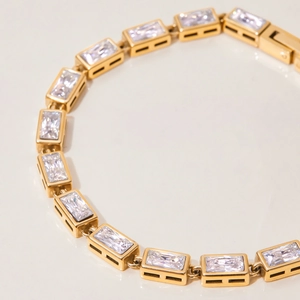 Detailed view of gold stainless steel bracelet with rectangular zircon stones in bezel setting