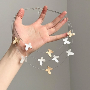 Three-layer butterfly pendant necklace in matte gold and silver finish with lobster clasp