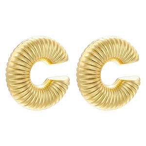 Detailed macro view of gold C-shaped earrings with intricate radial pleated textures