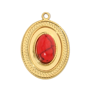 Detail of vintage gold titanium pendant with oval red stone and marble texture