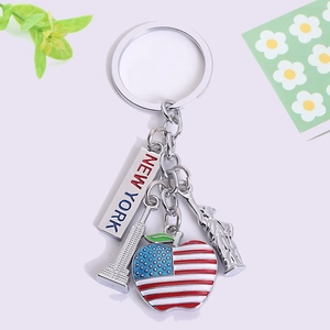 Detailed view of silver New York keychain with Statue of Liberty and US flag apple charms