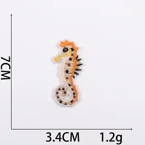 Detailed seahorse embroidery patch measuring 7cm by 3.4cm with orange accents