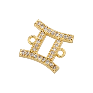 Macro shot of gold Gemini zodiac pendant featuring white cubic zirconia connectors