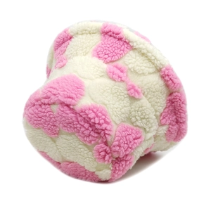 Detailed view of pink and beige heart jacquard sherpa fabric on a winter bucket hat
