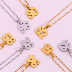 Detail of stainless steel 18K gold and silver plated necklaces with classic year pendant