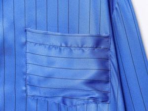Detailed view of the blue striped satin shirt fabric showing the smooth pocket stitching