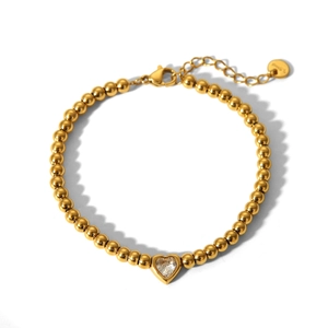 Detail of 18K gold stainless steel beaded bracelet with clear heart crystal and lobster clasp