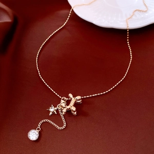 Close-up of 14K gold-plated balloon dog necklace with star and zircon details
