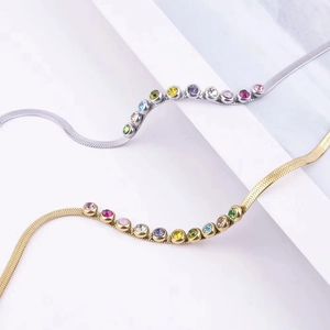 Colorful gemstone snake chain bracelet in gold and silver finish on white display