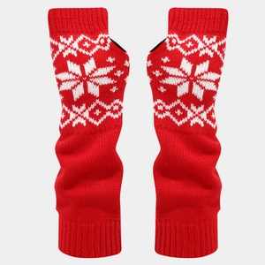 Detail of red winter knit arm warmers with white snowflake pattern and thumb holes