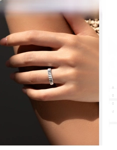 Macro detail of S925 sterling silver ring featuring industrial ripple texture on finger