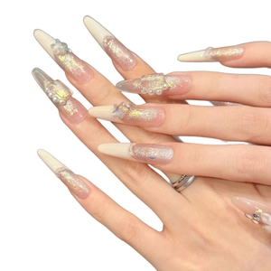 Handmade stiletto press-on nails in nude pink gradient with pearls and star glitter
