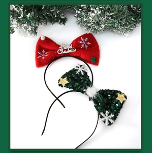 Close-up of red and green Christmas headbands with sequins and snowflake patterns