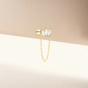 Close-up of S925 silver 16G piercing stud with three marquise gems and gold chain tassel