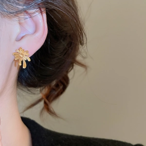 Close-up of gold plated fireworks earrings on model showing French vintage style and luster