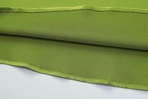 Detailed macro shot showing professional stitching on green chiffon maxi dress hemline