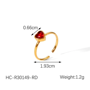 Detail view of 18k gold heart ring showing 1.93cm band width and 0.66cm red gemstone