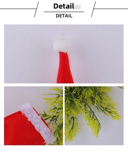Detail of red felt Christmas hat with white plush ball and faux green pine needles