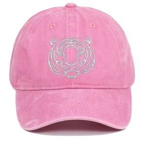 Macro detail of silver tiger head embroidery on washed pink cotton baseball cap