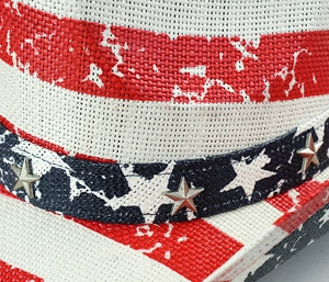 Close-up of straw cowboy hat with US flag stripes and blue star band with metal rivets