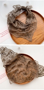 Detailed view of brown floral lace triangle scarf with intricate embroidery texture