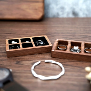 Macro detail of dark walnut jewelry box with black velvet lining and silver bangle