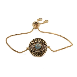 Detail of gold Evil Eye bracelet with blue crystal inlay and adjustable slider clasp