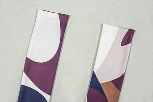 Detail of abstract geometric print and fine stitching on a lightweight A-line dress