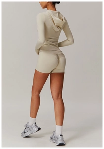 Detail of scrunch butt seam on cream high-waisted yoga shorts and matching hoodie set