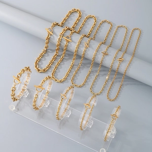 Detailed set of gold O-chain necklaces and bracelets with T-bar toggles on display
