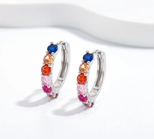 Macro view of multi-color gemstone cluster earrings with polished silver finish
