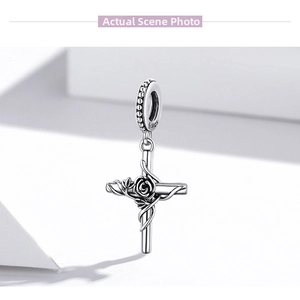 Detailed view of S925 sterling silver cross pendant with intricate rose and vine engraving